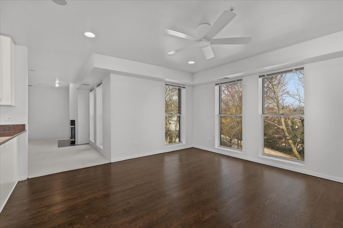 380 Green Bay Road, Unit 4D Winnetka, IL 60093 - Photo 11 of 25 a view of an empty room with wooden floor and a window