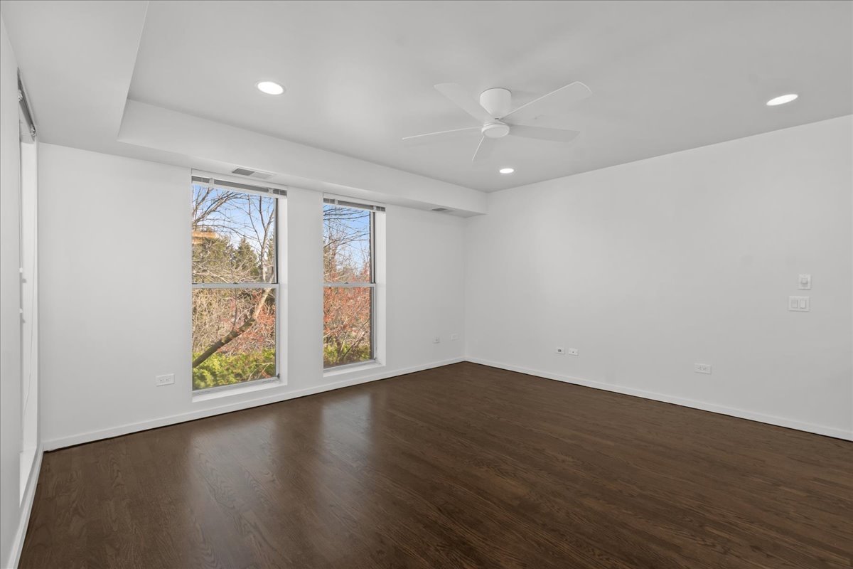 380 Green Bay Road, Unit 4D Winnetka, IL 60093 - Photo 15 of 25 an empty room with wooden floor and windows
