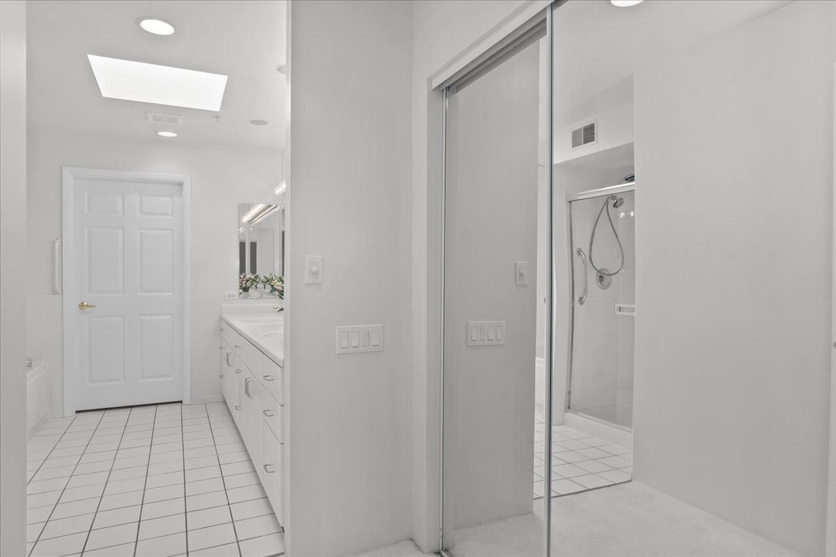 380 Green Bay Road, Unit 4D Winnetka, IL 60093 - Photo 21 of 25 a bathroom with a sink a mirror and shower