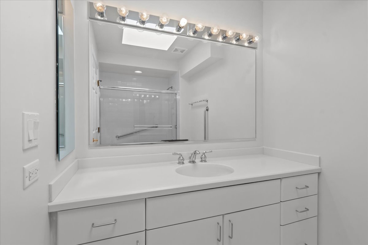 380 Green Bay Road, Unit 4D Winnetka, IL 60093 - Photo 23 of 25 a bathroom with a sink and a mirror