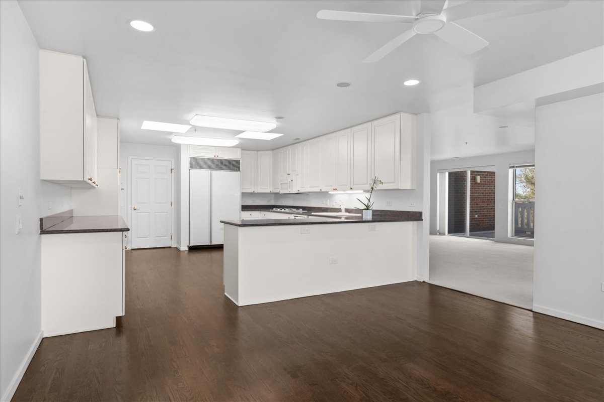 380 Green Bay Road, Unit 4D Winnetka, IL 60093 - Photo 10 of 25 a kitchen with stainless steel appliances a refrigerator sink and white cabinets