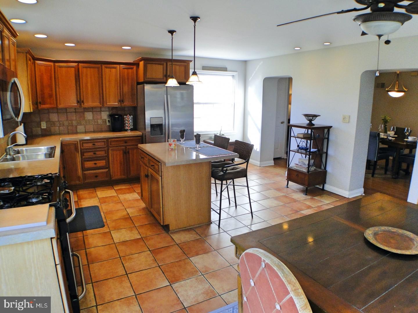 416 Valley View Road Springfield, PA 19064 - Photo 14 of 40 a kitchen with stainless steel appliances granite countertop a stove a sink and a refrigerator