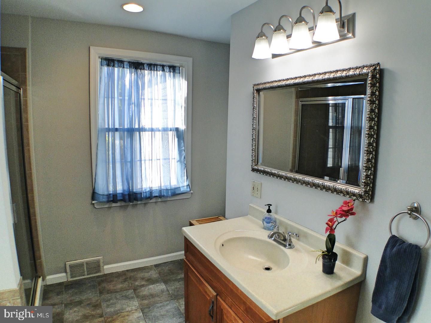 416 Valley View Road Springfield, PA 19064 - Photo 22 of 40 a bathroom with a sink and a mirror