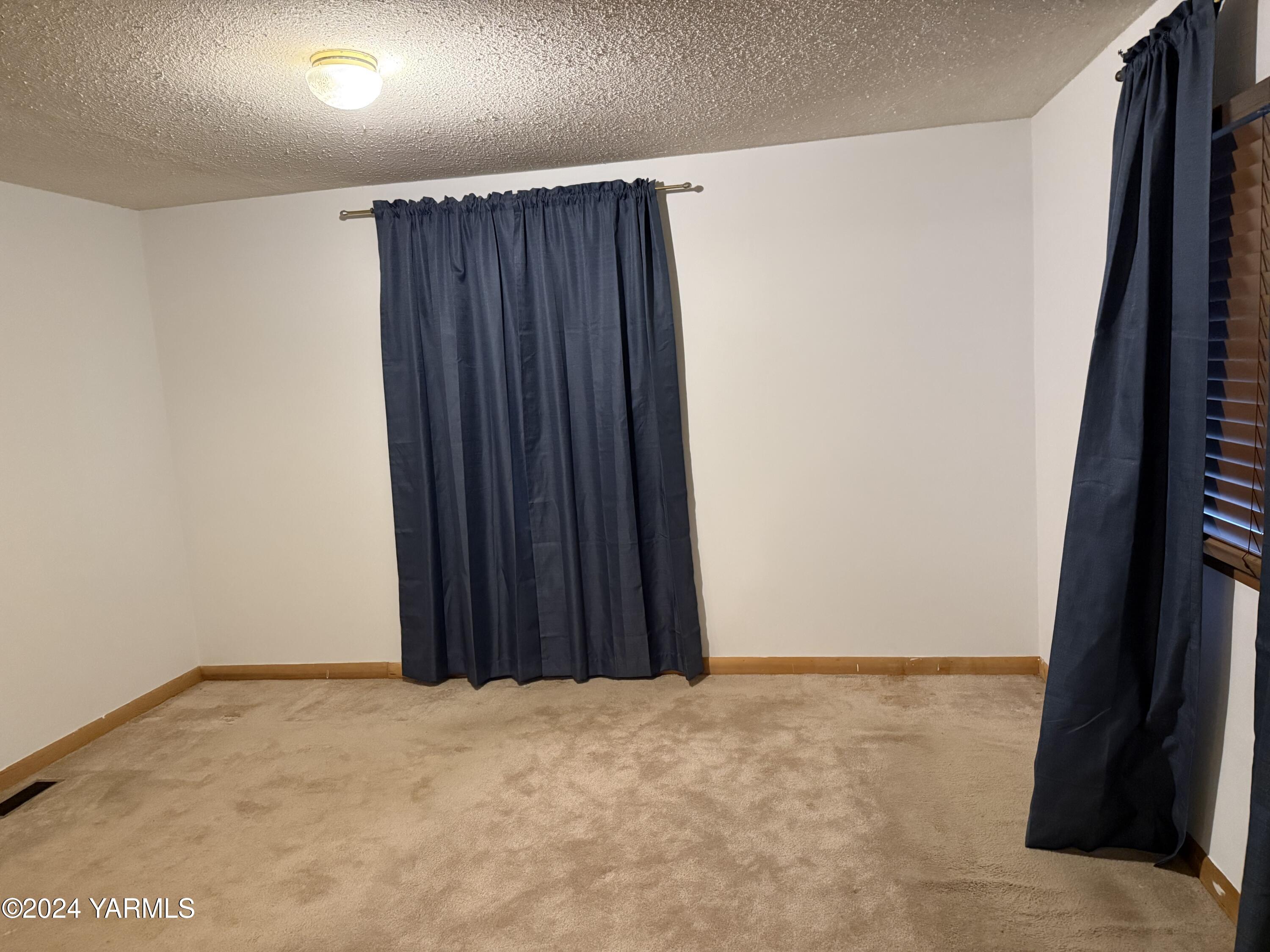 19101 North Beers Road Prosser, WA 99350 - Photo 19 of 45 an empty room with a wooden door