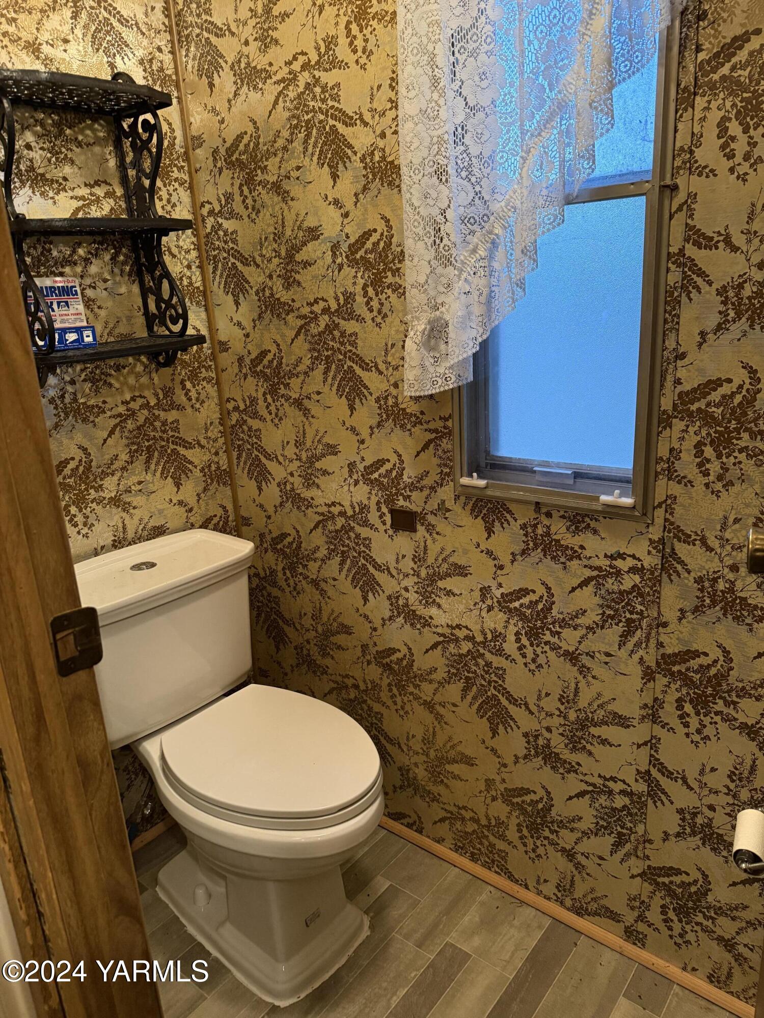 19101 North Beers Road Prosser, WA 99350 - Photo 23 of 45 a white toilet sitting next to a shower curtain