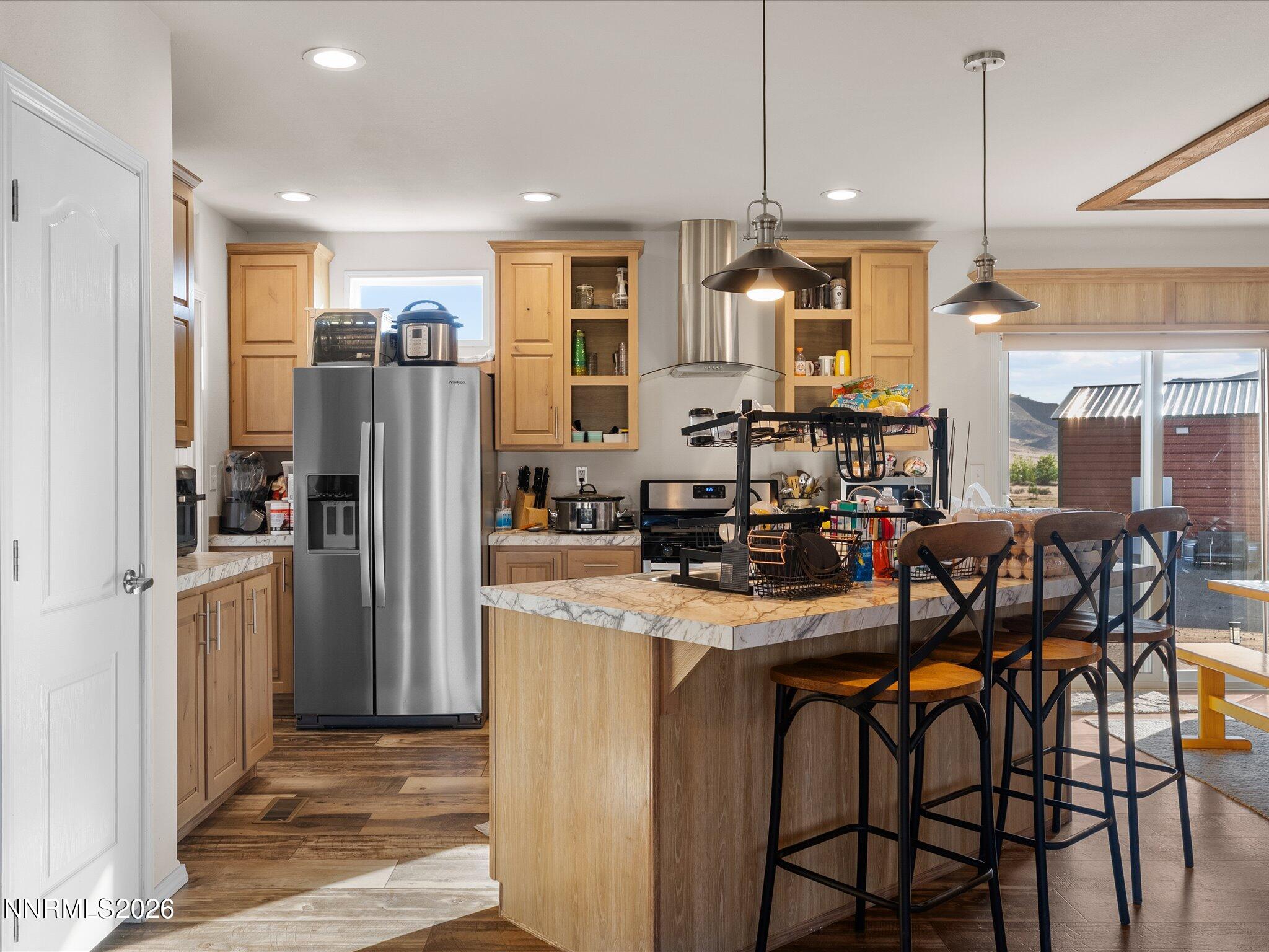 4555 Amy Road Reno, NV 89510 - Photo 11 of 74 a kitchen with stainless steel appliances a refrigerator a sink a stove a dining table and chairs