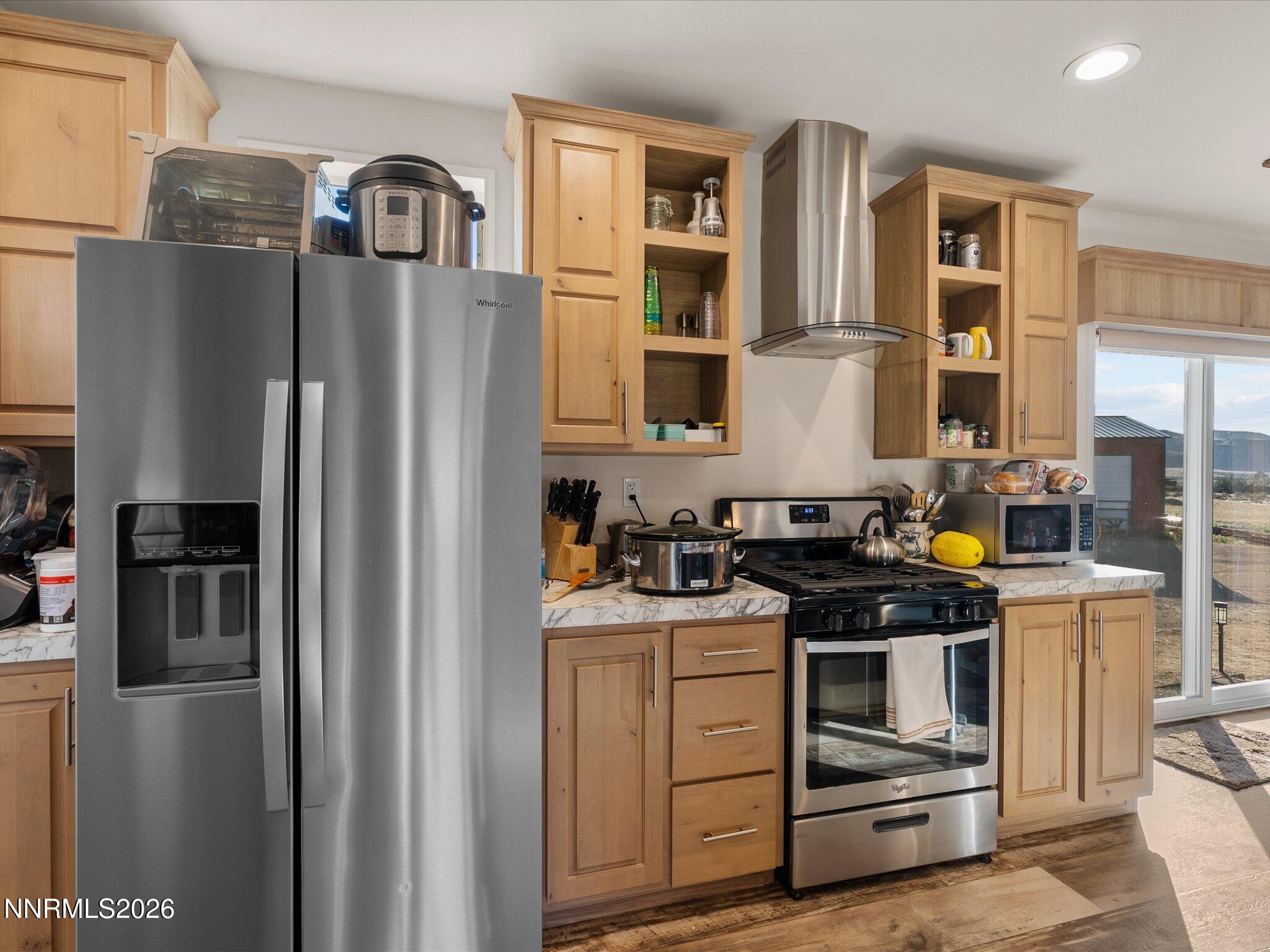 4555 Amy Road Reno, NV 89510 - Photo 15 of 74 a kitchen with stainless steel appliances granite countertop a refrigerator a stove and a sink with wooden floor