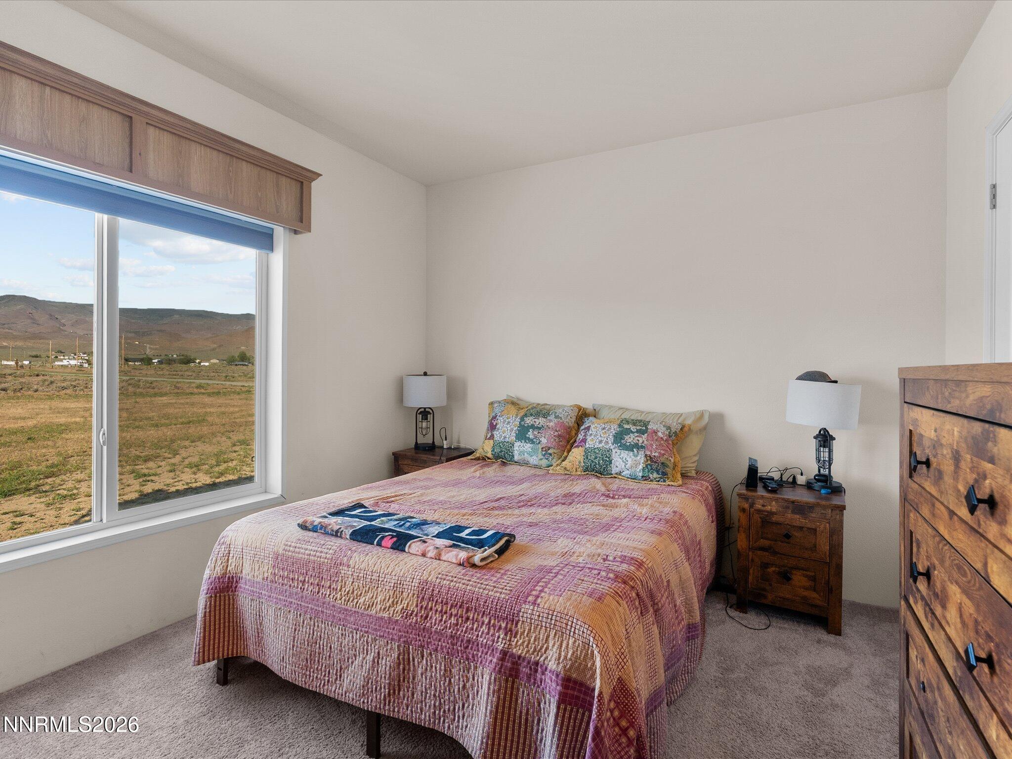 4555 Amy Road Reno, NV 89510 - Photo 21 of 74 a bedroom with a bed and a large window