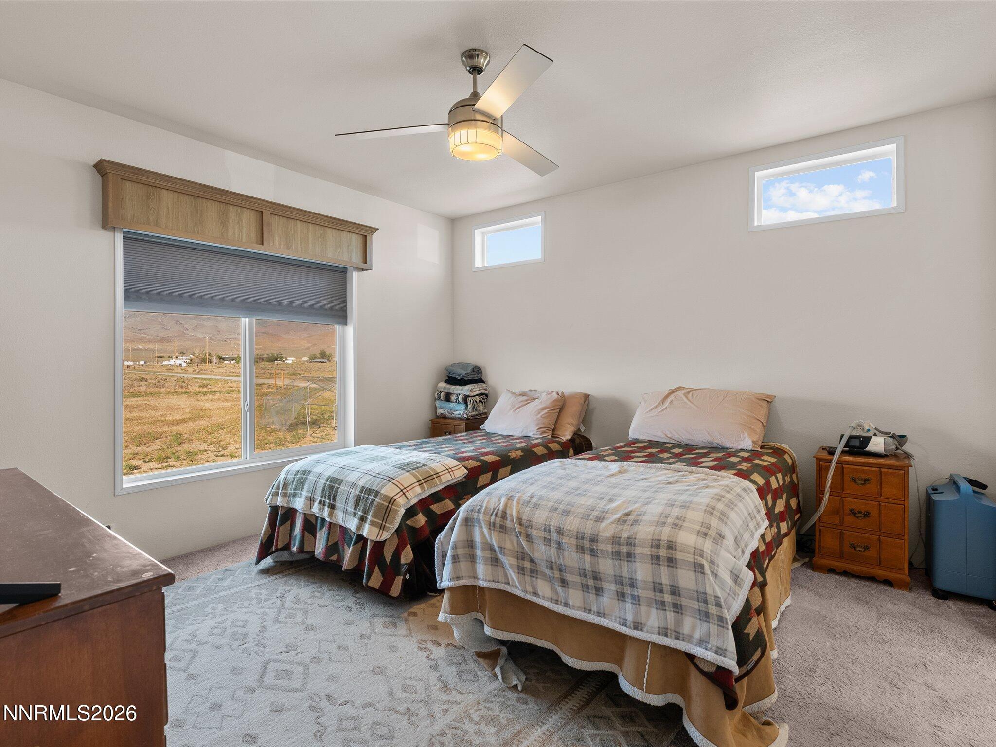 4555 Amy Road Reno, NV 89510 - Photo 25 of 74 a bedroom with two beds and a chandelier