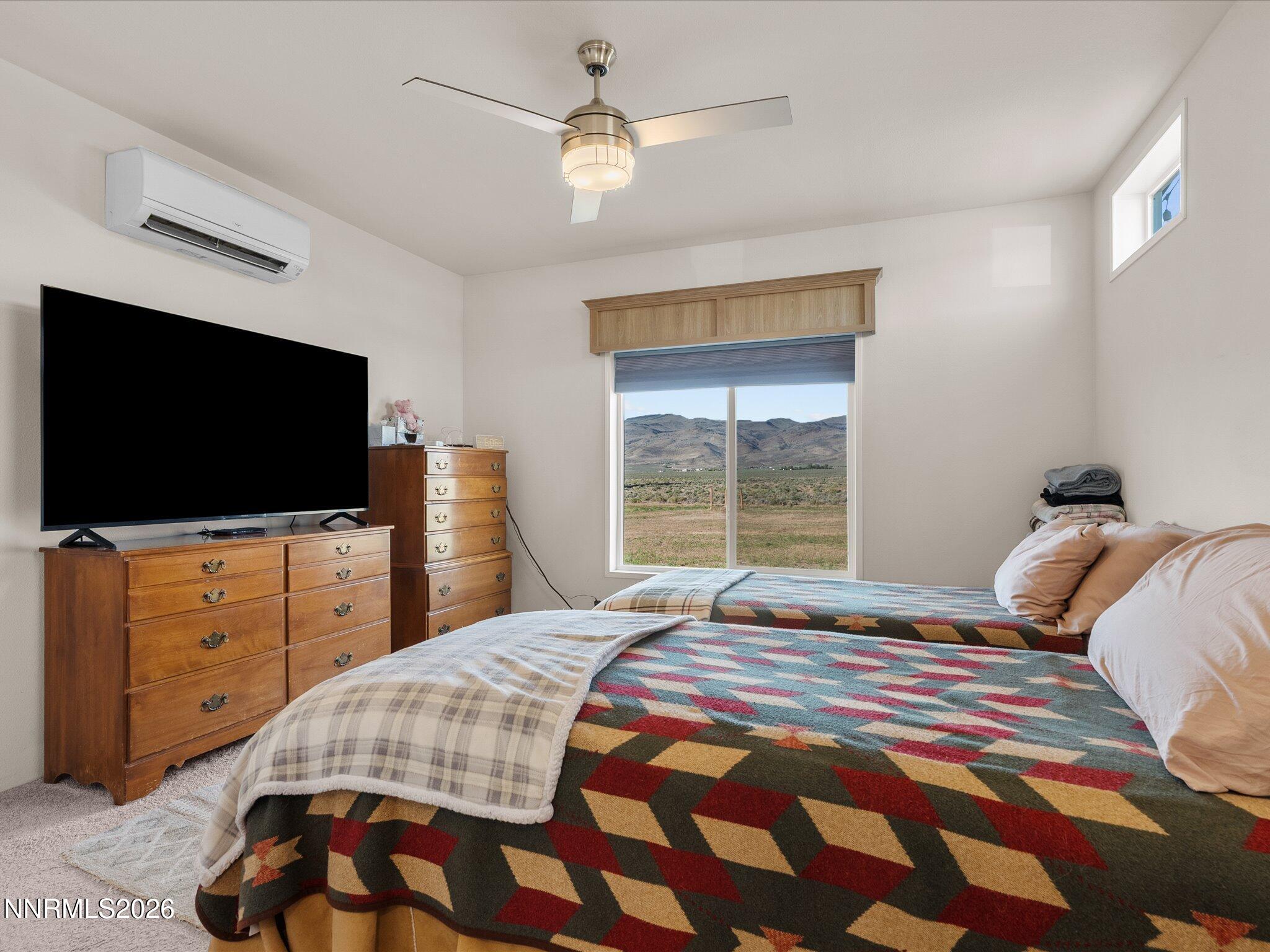 4555 Amy Road Reno, NV 89510 - Photo 27 of 74 a bedroom with a bed and a flat screen tv
