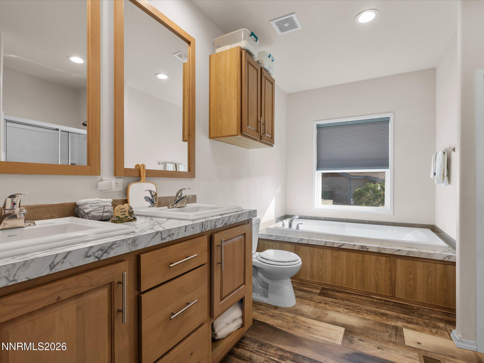 4555 Amy Road Reno, NV 89510 - Photo 28 of 74 a bathroom with a granite countertop toilet sink and mirror