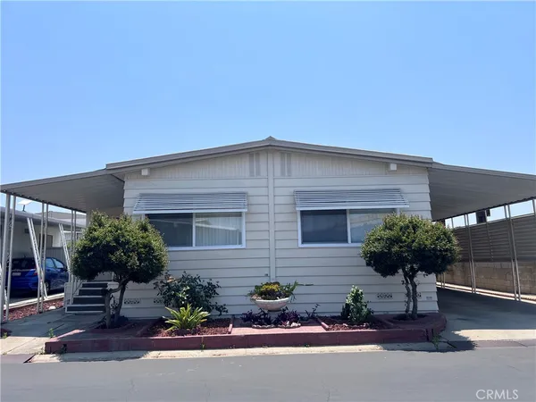 a front view of a house with a yard and outdoor seating