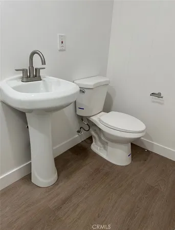 a bathroom with a sink toilet and a mirror