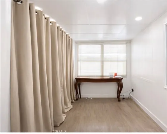 a view of room with window and furniture