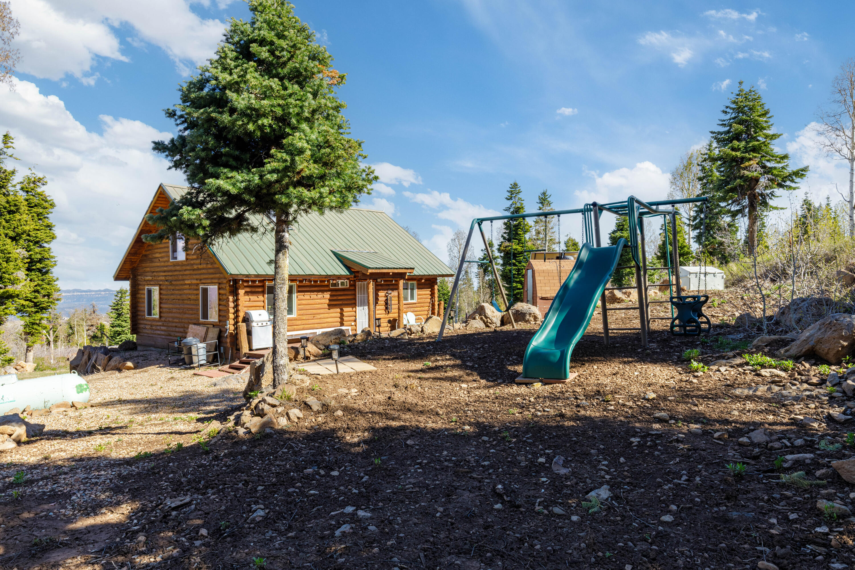 706 West Tranquility Drive Springdale, UT 84767 - Photo 27 of 58 Playset & Backyard: Highlight of the outdoor play area.