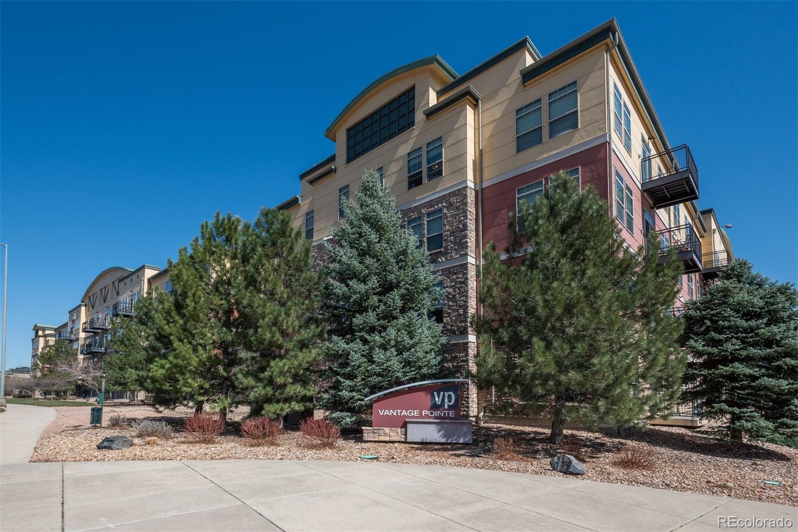13456 Via Varra, Unit 208 Broomfield, CO 80020 - Photo 1 of 33 a front view of a house with a yard