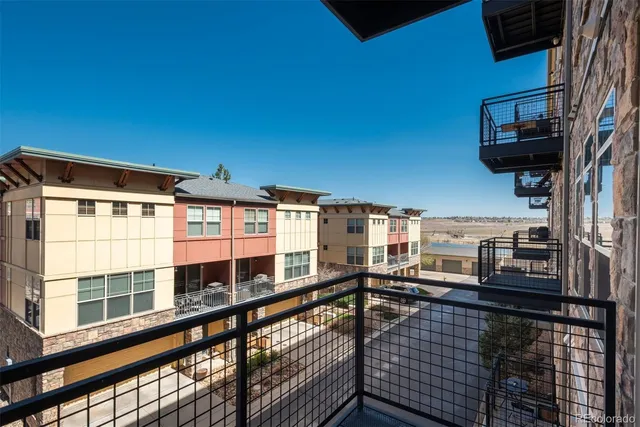 a view of a balcony with a floor to ceiling window and wooden floor