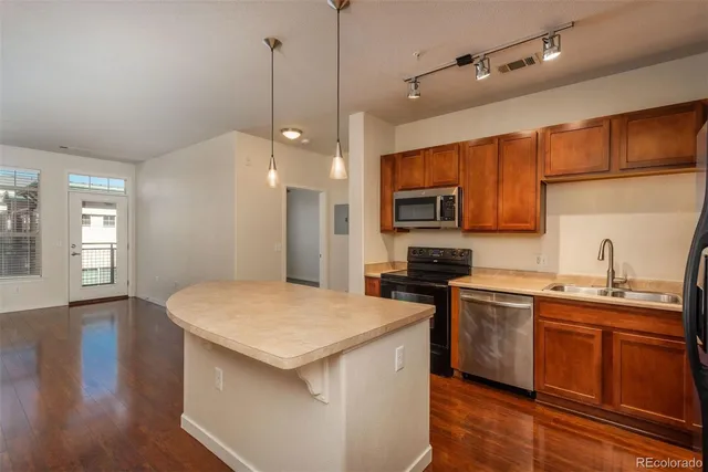 a kitchen with granite countertop a sink appliances and cabinets