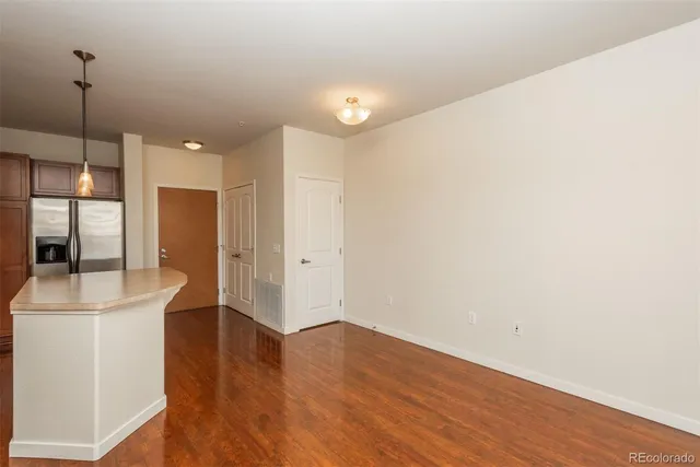 a view of a kitchen with furniture and wooden floor