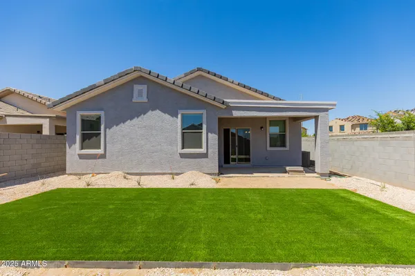 a front view of a house with a garden and yard