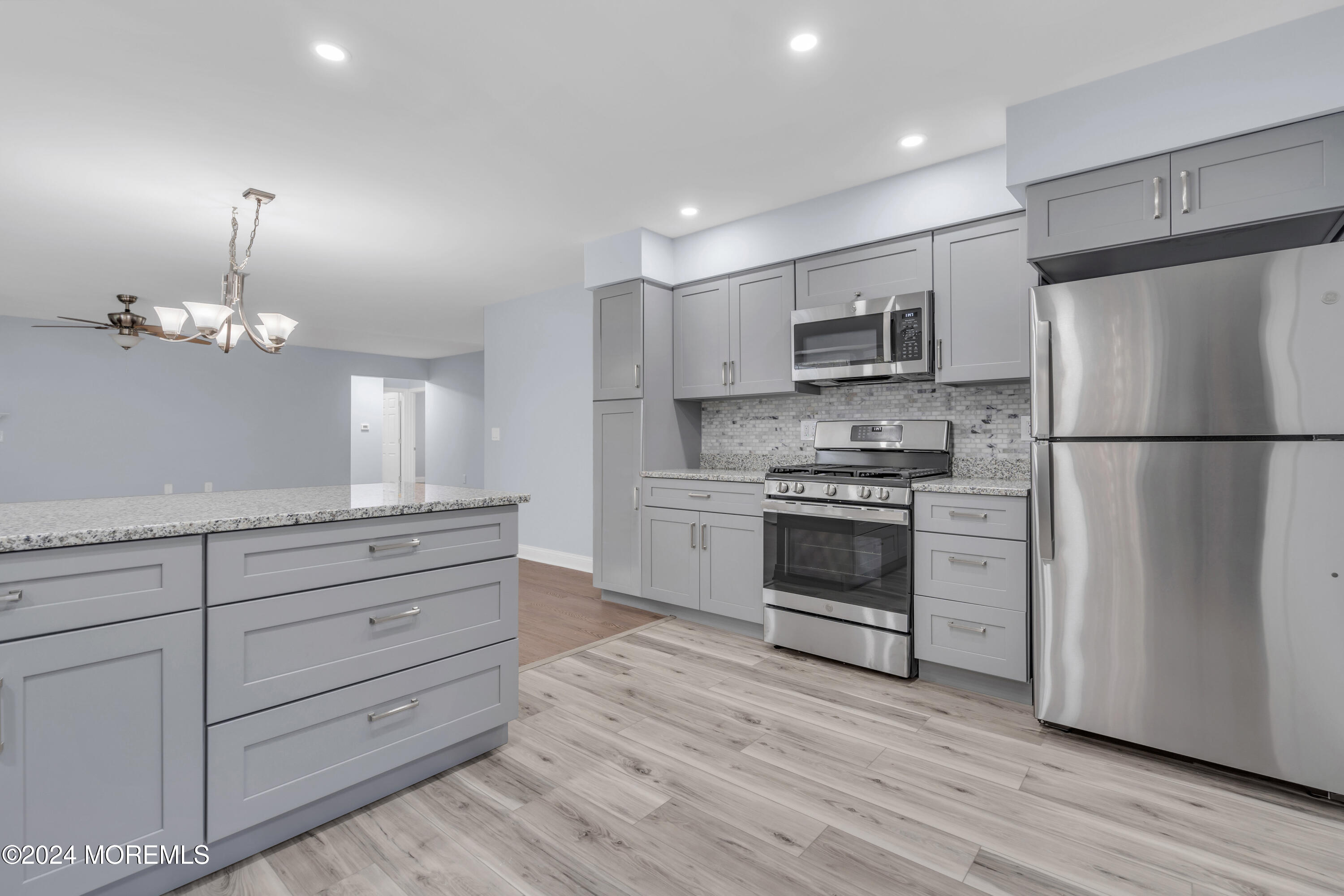 239 Sunset Drive Forked River, NJ 08731 - Photo 12 of 35 a kitchen with a refrigerator and a stove top oven