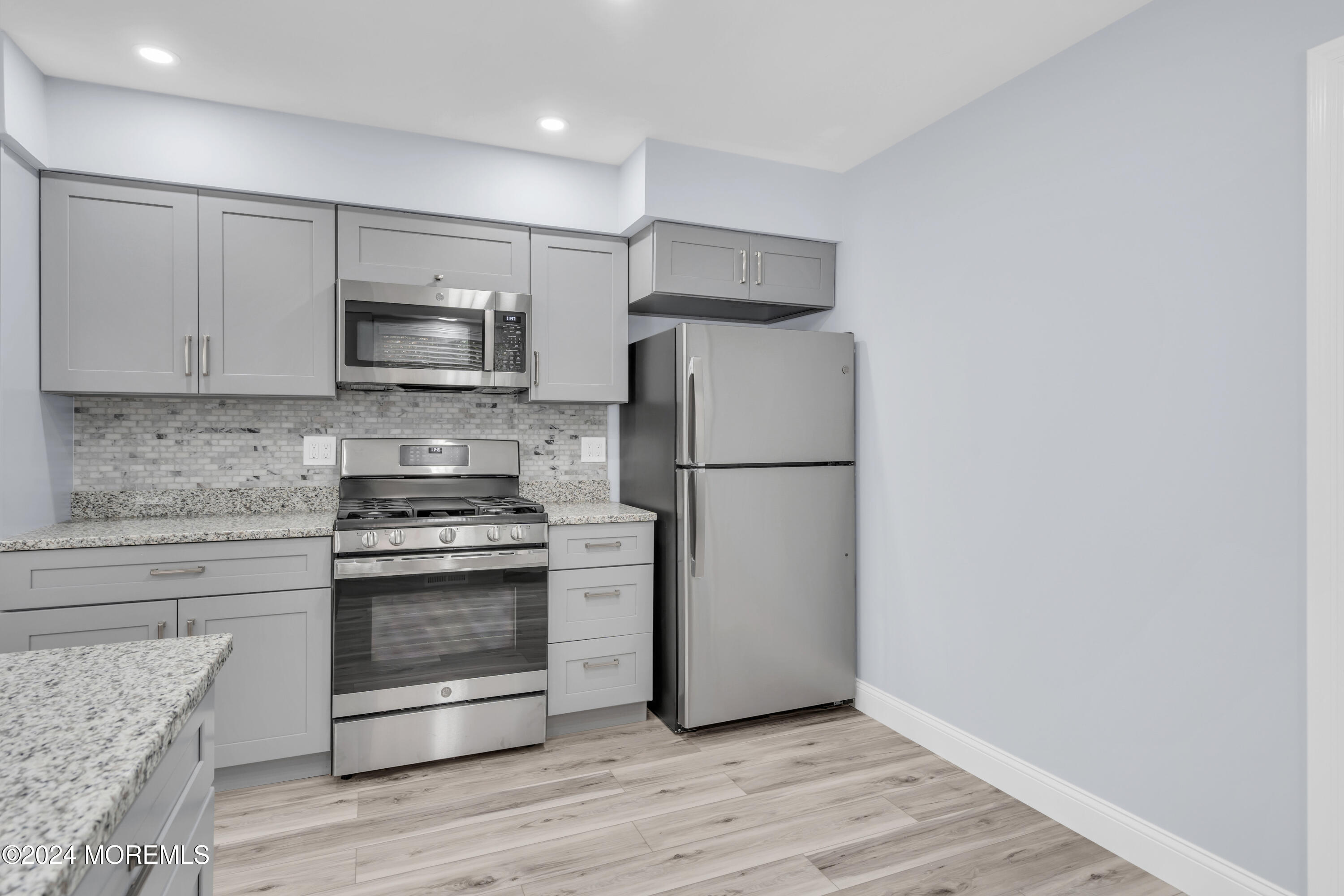 239 Sunset Drive Forked River, NJ 08731 - Photo 13 of 35 a kitchen with a refrigerator stove and white cabinets