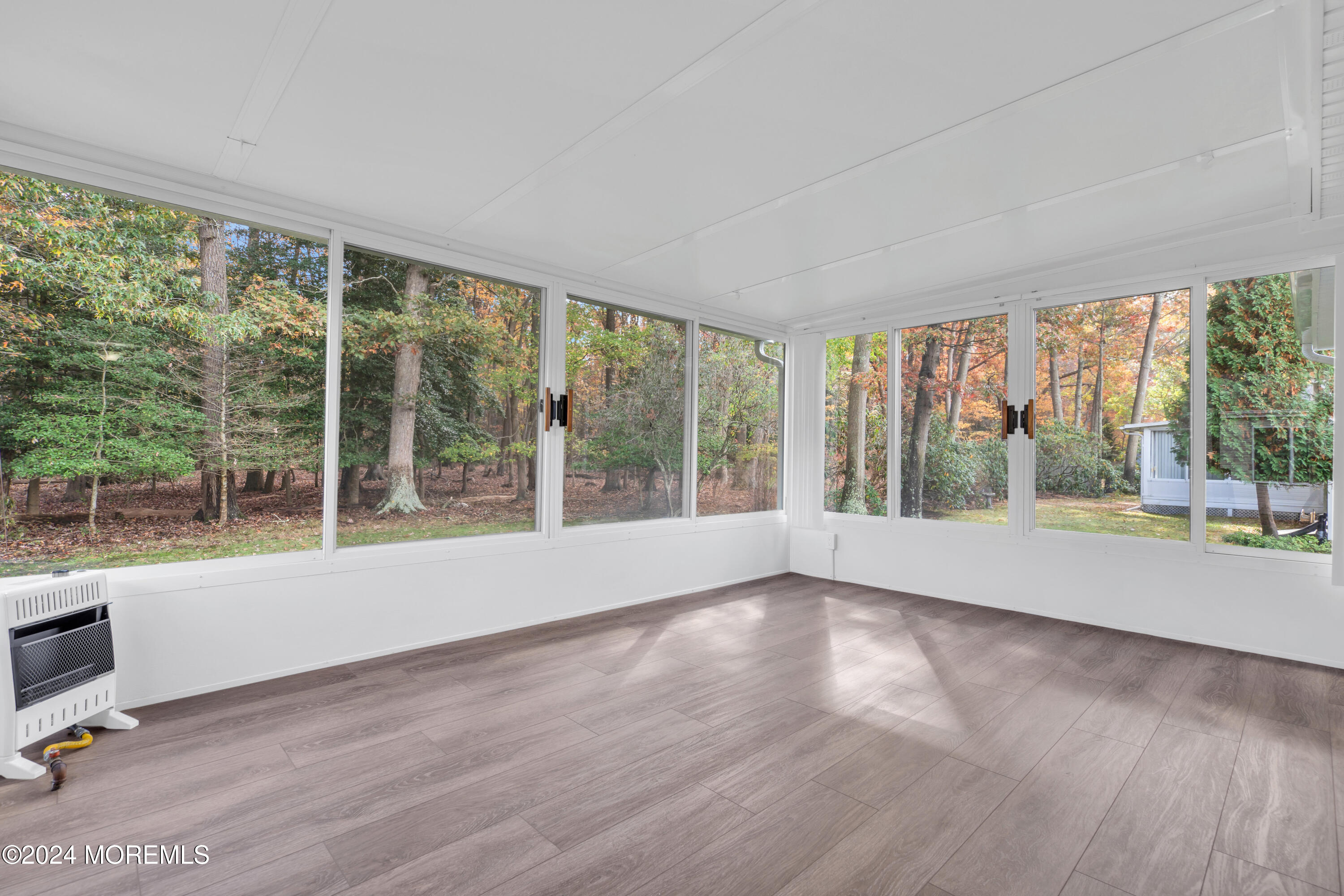 239 Sunset Drive Forked River, NJ 08731 - Photo 20 of 35 a view of an empty room with wooden floor and a window