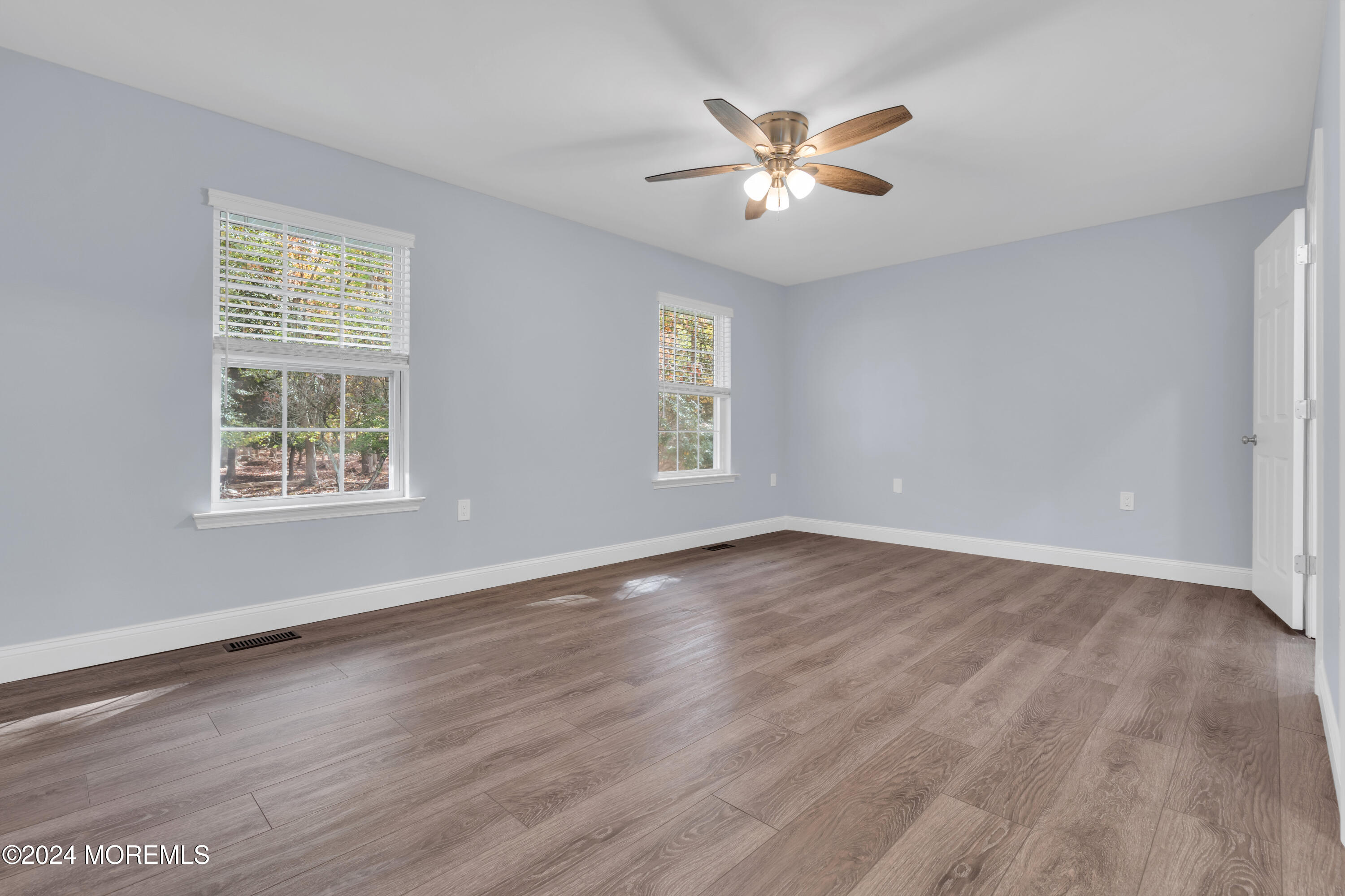 239 Sunset Drive Forked River, NJ 08731 - Photo 22 of 35 a view of an empty room with wooden floor and a window