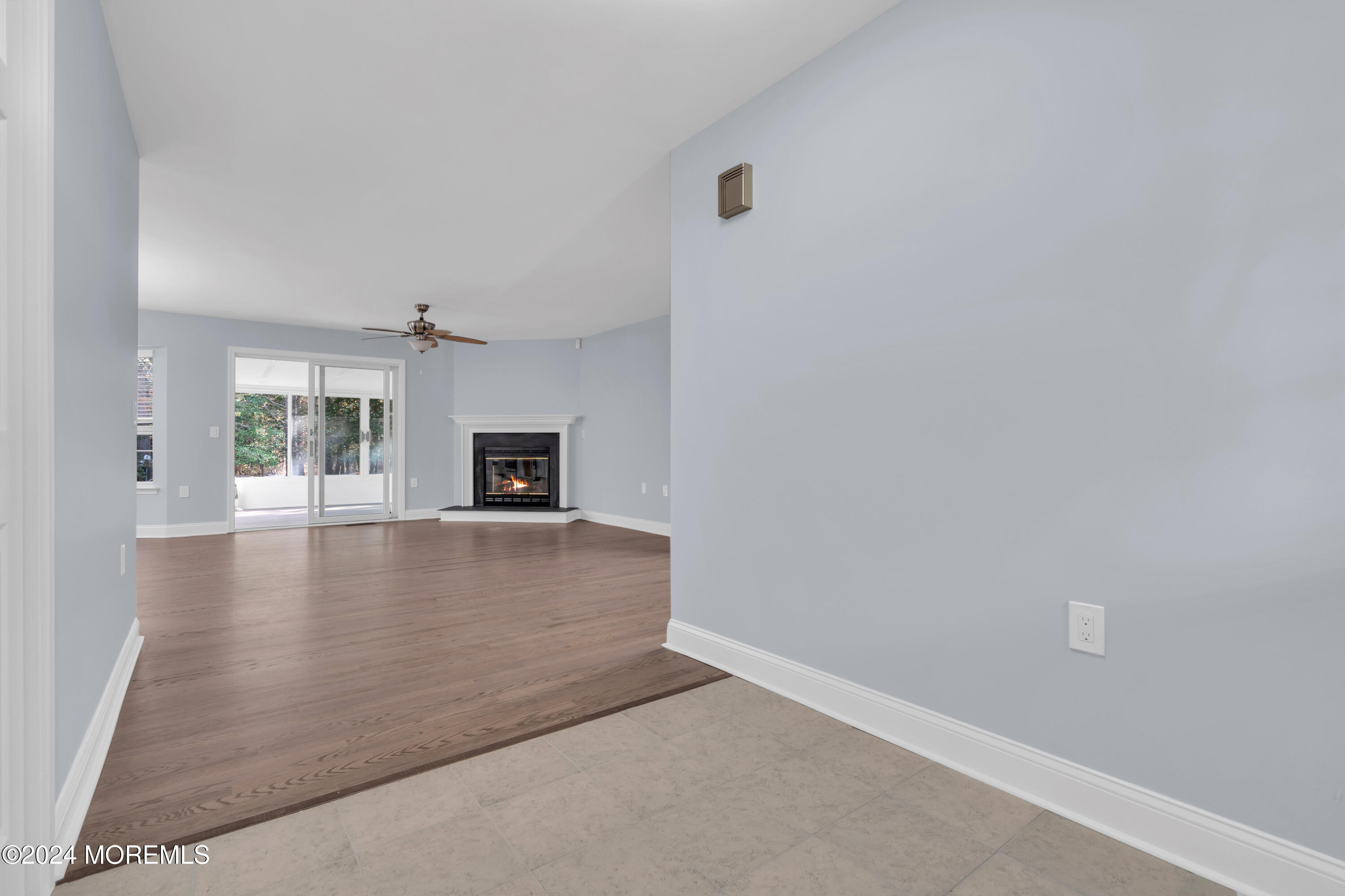 239 Sunset Drive Forked River, NJ 08731 - Photo 6 of 35 an empty room with wooden floor and fireplace