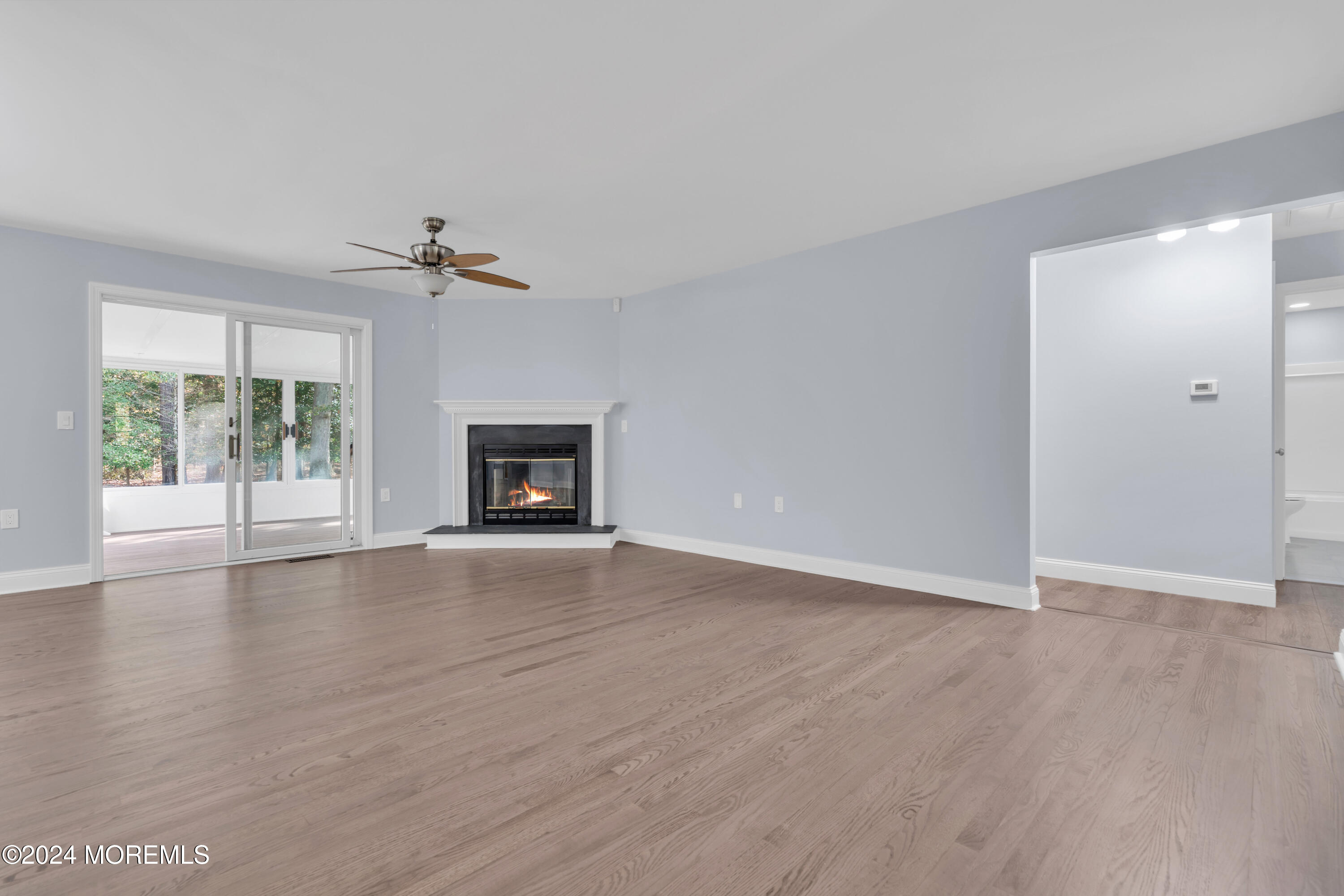 239 Sunset Drive Forked River, NJ 08731 - Photo 7 of 35 a view of an empty room with wooden floor and a window