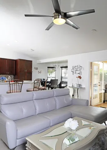a living room with furniture and a chandelier