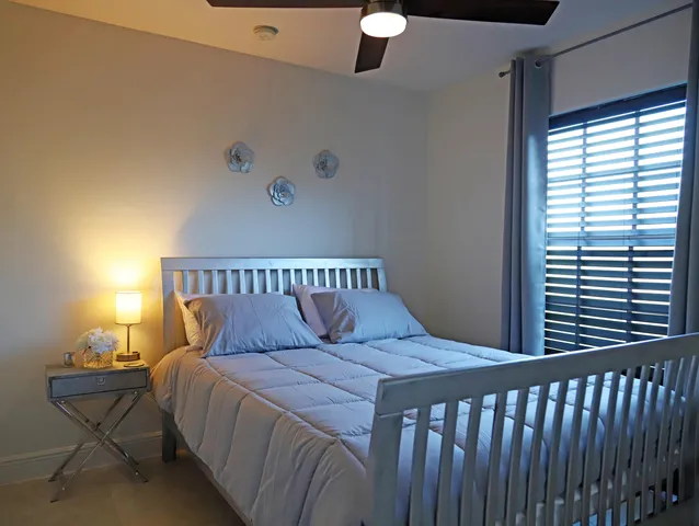 a bed sitting in a bedroom next to a window