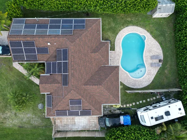 an aerial view of a house with a swimming pool garden and outdoor seating