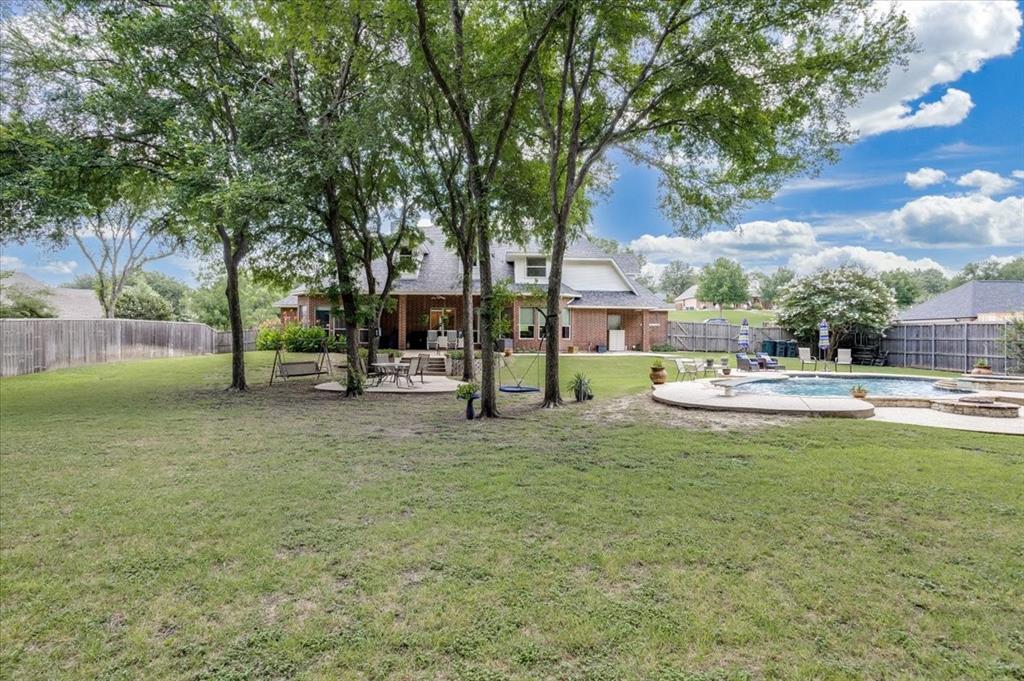 3025 Keri Lane Midlothian, TX 76065 - Photo 18 of 27 Expansive backyard featuring a large in-ground swimming pool, a concrete patio, and a privacy fence