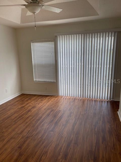 8837 White Sage Loop Lakewood Ranch, FL 34202 - Photo 16 of 22 an empty room with wooden floor and windows