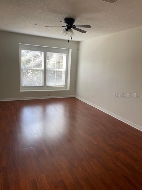 8837 White Sage Loop Lakewood Ranch, FL 34202 - Photo 3 of 22 an empty room with wooden floor and windows