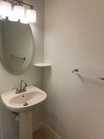 a bathroom with a sink and mirror