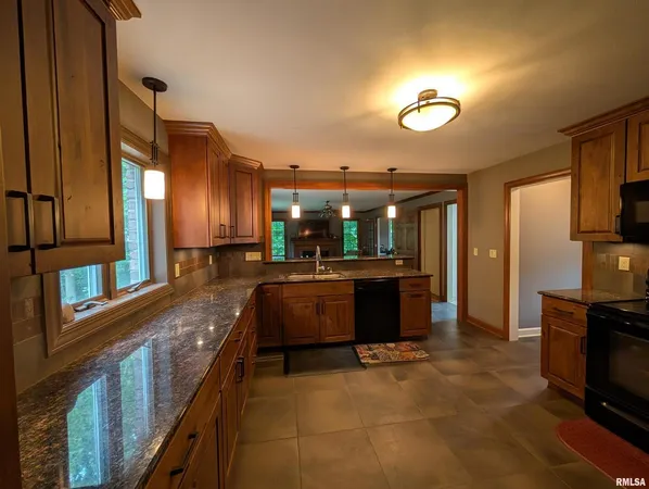 a large kitchen with a large counter top appliances and cabinets