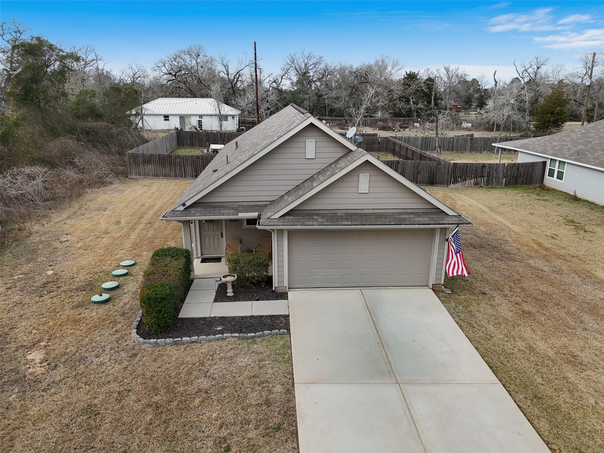 26431 Pin Oak Drive Hempstead, TX 77445 - Photo 30 of 32 Aerial front approach view highlighting the home’s setting, long driveway, and quiet neighborhood surroundings.