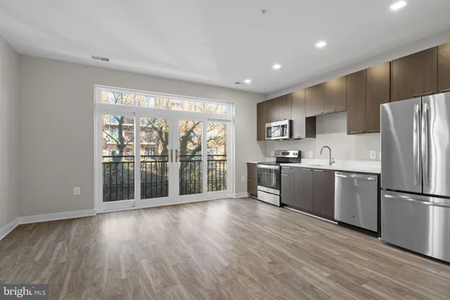 a kitchen with a refrigerator a sink and a large window