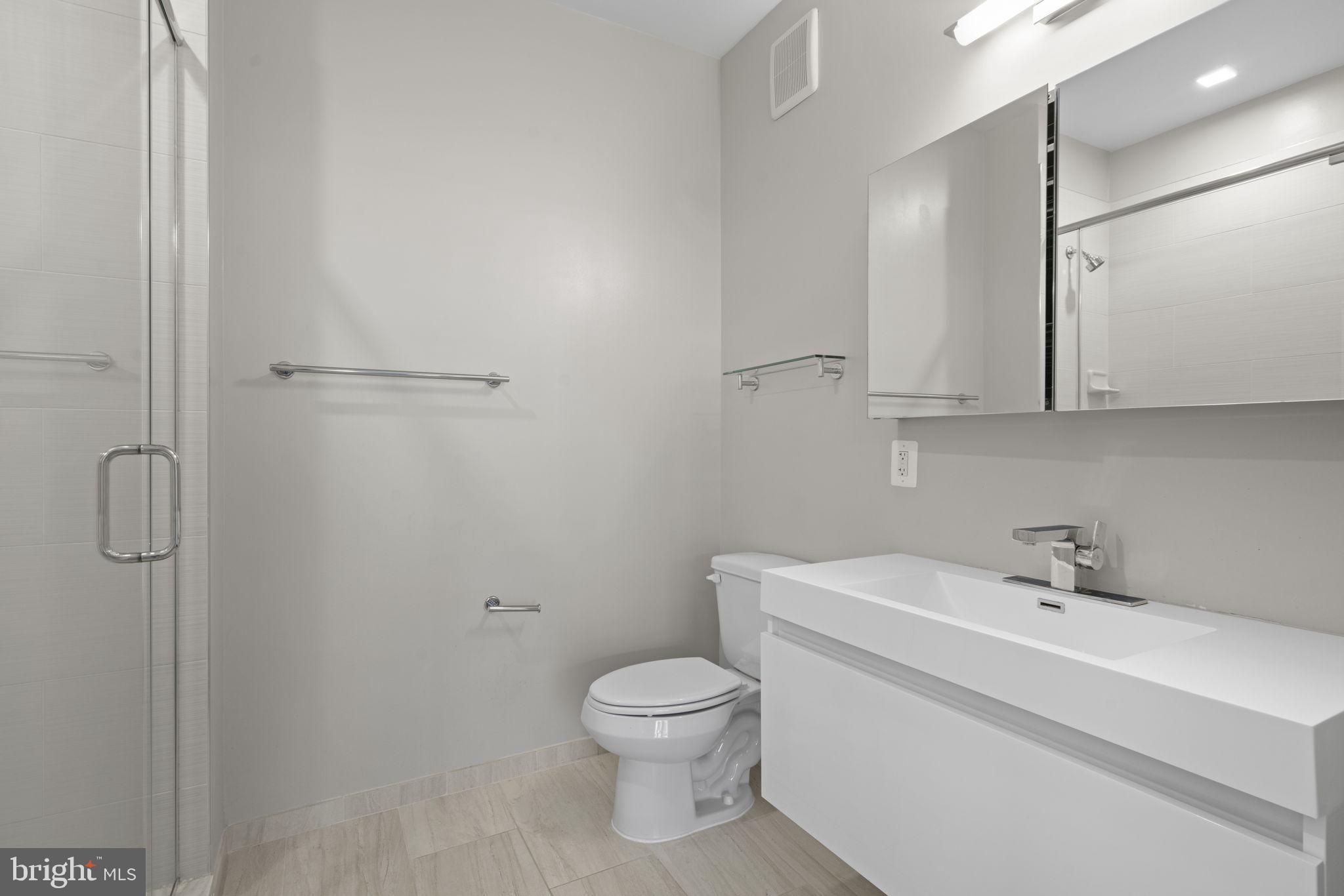 989 South Buchanan Street, Unit 312 Arlington, VA 22204 - Photo 23 of 45 a bathroom with a sink a toilet and shower