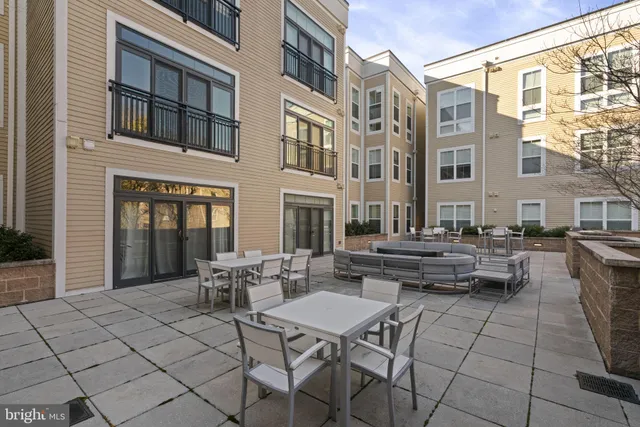 a view of a dinning tables and chairs in a patio