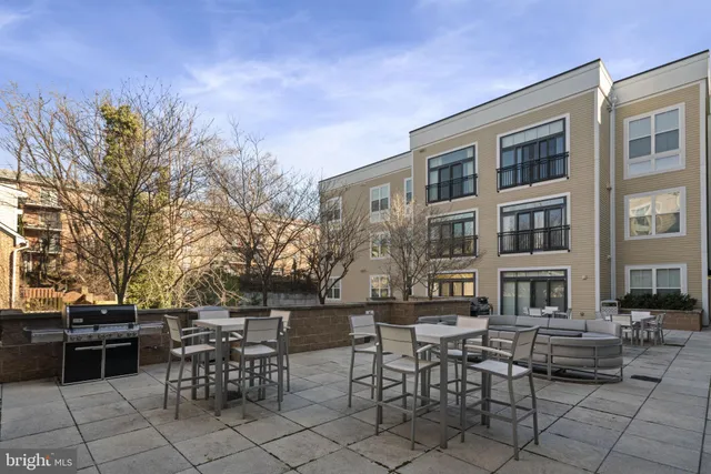 a view of a patio with table and chairs and potted plants
