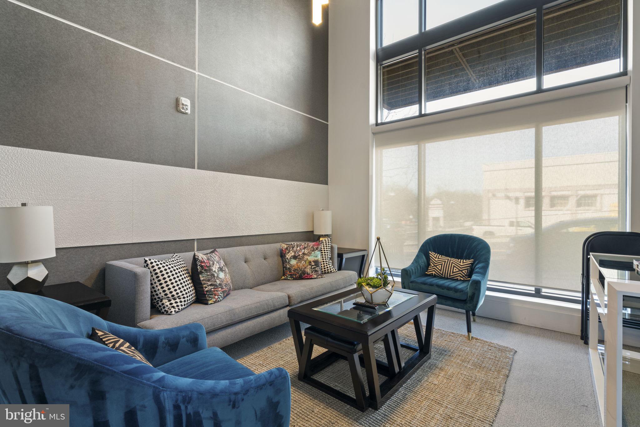 989 South Buchanan Street, Unit 312 Arlington, VA 22204 - Photo 9 of 45 a living room with furniture and a large window