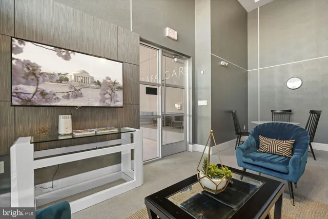 a living room with furniture and a floor to ceiling window