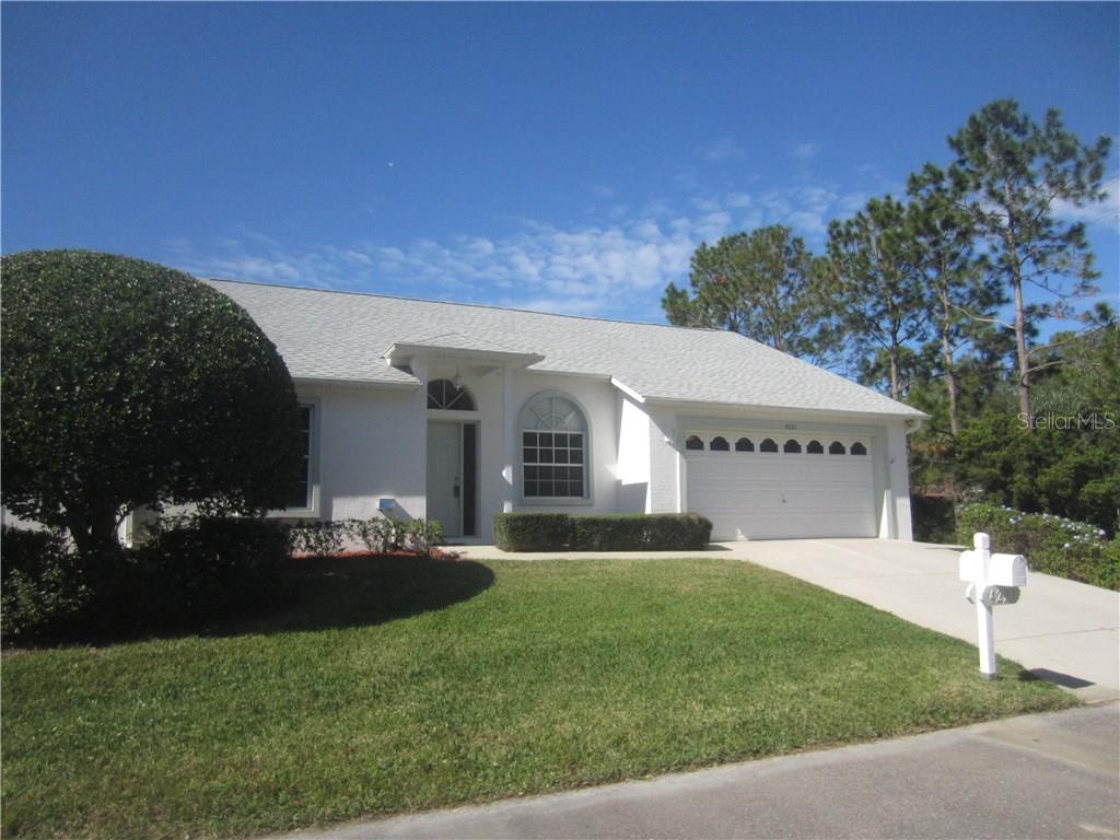 4221 Prado Lane New Port Richey, FL 34655 - Photo 1 of 1 a front view of a house with a garden