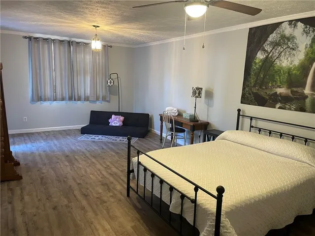 a bed sitting in a bedroom next to a window