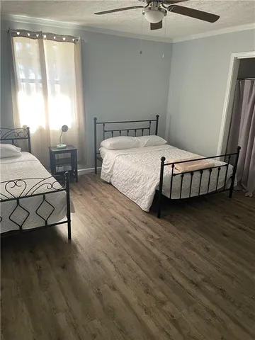 a bedroom with a bed a table and chair