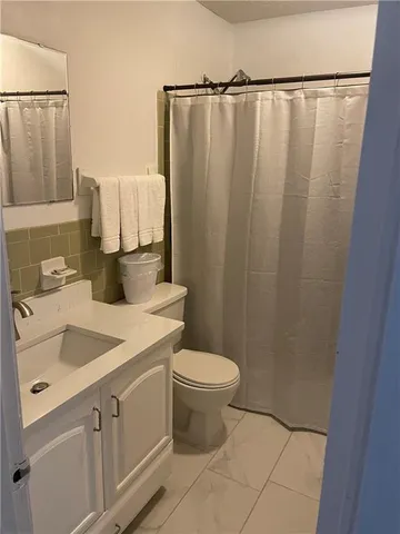 a view of a backyard with table and chairs under an umbrella