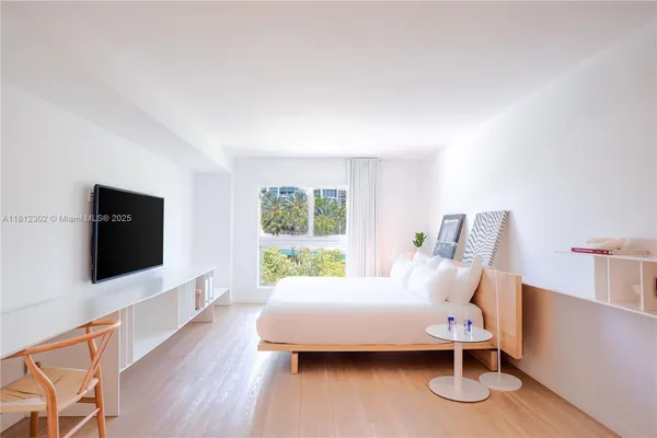 a bedroom with furniture and a flat screen tv